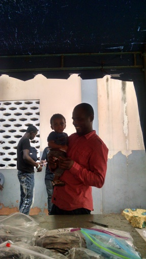John, a driver for Crystal, playing with a small boy on outreach